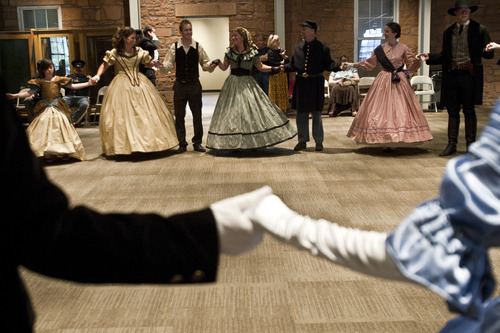 Chris Detrick  |  The Salt Lake Tribune 

Couples dance the Oslo waltz during a Civil War ball at the Fort Douglas Museum on Friday. Several dozen re-enacters and historical dancers swept across the floor, dancing reels and quadrilles, contras and country dances in the new addition to the Fort Douglas Museum on the University of Utah campus.