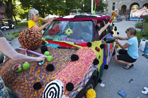 Photo by Chris Detrick | The Salt Lake Tribune 
Volunteers with Blazing Needles knit around Jocelyn Kearl's Mini Cooper for the Utah Arts Festival at Washington Square Tuesday June 21, 2011.  For the past three months, over fifty people have been knitting an estimated 20,000 yards of yarn for this project.