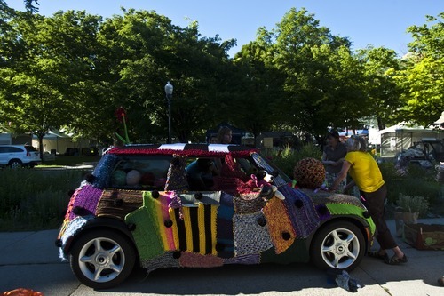 Chris Detrick | The Salt Lake Tribune 
Volunteers with Blazing Needles knit around Jocelyn Kearl's Mini Cooper for the Utah Arts Festival at Washington Square on Tuesday June 21, 2011.  More than 50 people have been knitting an estimated 20,000 yards of yarn for the past three months for this project.