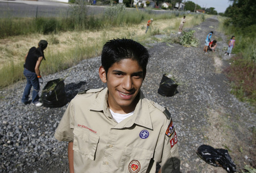 Francisco Kjolseth  |  The Salt Lake Tribune
Howard Saavedra, working on his Eagle Scout service project, organized about 200 people for a clean-up at the old Union Pacific rail 900 South corridor. The city plans to turn the corridor into a bike path and park. The clean-up began at Park View Elementary on Saturday, June 18, 2011.