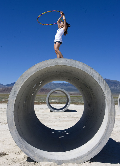 Al Hartmann  |  The Salt Lake Tribune
Tara Thornley, does some free form hula hoop atop the Sun Tunnels, celebrating Summer Solstice on Tuesday, June 21 near Lucin.
