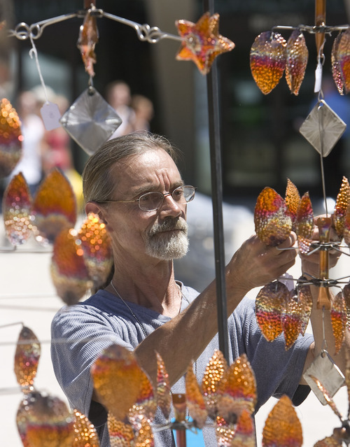 Al Hartmann  |  The Salt Lake Tribune
Logan metal artist William Hedgecock finishes setting up a display of movable metal sculptures during the opening of the Utah Arts Festival on Thursday in downtown Salt Lake City. It continues through Sunday.