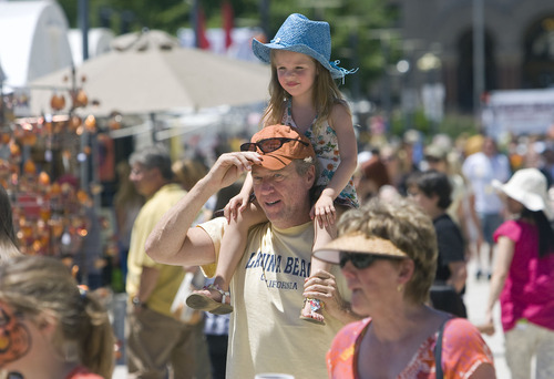 Al Hartmann  |  The Salt Lake Tribune
Sophia Lyon, 4,  gets a ride on the shoulders of her father Paul during the opening hour of the Utah Arts Festival in Salt Lake City on Thursday. It was a hot opening day, with temperatures in the mid-90s.