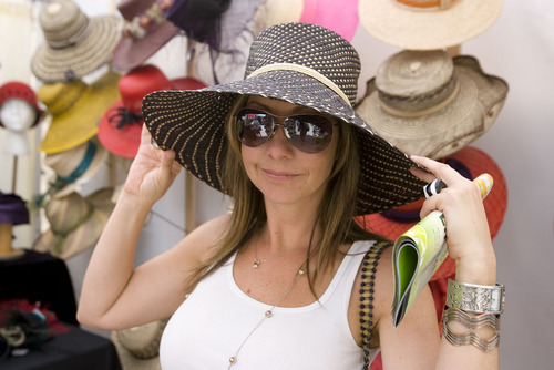 Al Hartmann  |  The Salt Lake Tribune
Tracey Kleinmeyer of Salt Lake City admires herself in the mirror with a Panama hat from Della Goheen Millinery at the Utah Arts Festival on Thursday. Della Goheen Millinery shapes hats by hand the old-fasioned way using old hat blocks and steam.