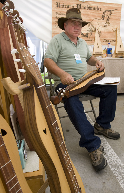 Al Hartmann  |  The Salt Lake Tribune
Johnie Nicholson of Caldwell, Idaho, plays one of his hand-made dulcimers at his booth at the Utah Arts Festival at Library Square in Salt Lake City on Thursday.
