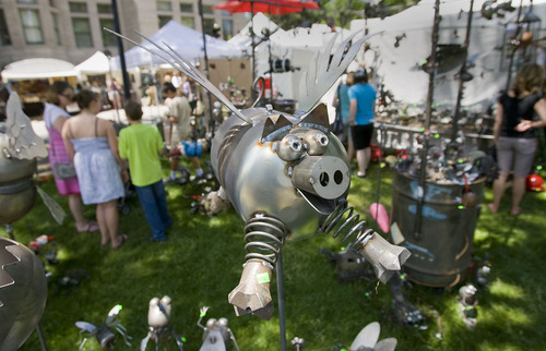Al Hartmann  |  The Salt Lake Tribune
A happy flying pig welded together of found metal pieces are one of many metal sculptures by local artist Fred Conlin seen during the opening hours of the Utah Arts Festival in Salt Lake City on Thursday. It continues through Sunday at Library Square.