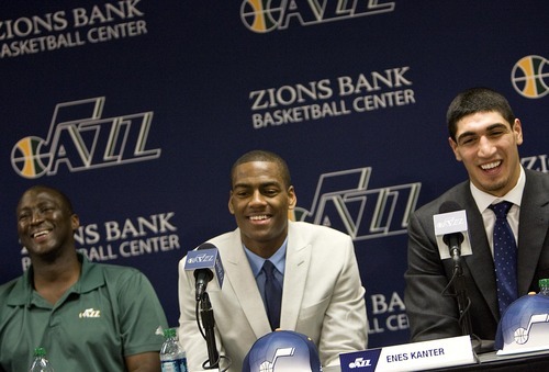 Utah Jazz first round NBA draft picks Enes Kanter, center and Alec Burks, right, with Jazz coach Tyrone Corbin, left, take questions during a news conference at the Zions Bank Basketball Center in Salt Lake City, Utah, on Friday, June 24, 2011. (AP Photo/The Salt Lake Tribune, Djamila Grossman)