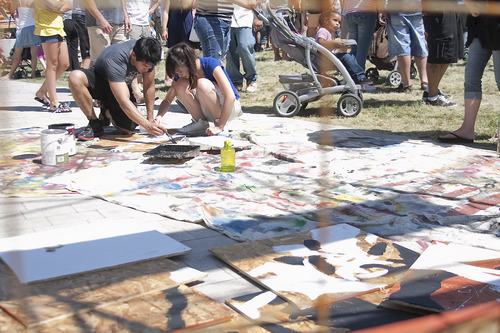 Margaret Distler  |  The Salt Lake Tribune

Nhi Doan and Tessie Pham paint one of the 100 total squares part of artist Mason Fetzer's community collaboration mural at the Utah Arts Festival on Saturday, June 25, 2011. Fetzer divided a picture into 100 pieces, which festival participants are painting onto wooden squares to create the 20x20 foot mural. While this is not Fetzer's first collaboration mural, it is his largest, with the previous largest one being 7x7 feet.