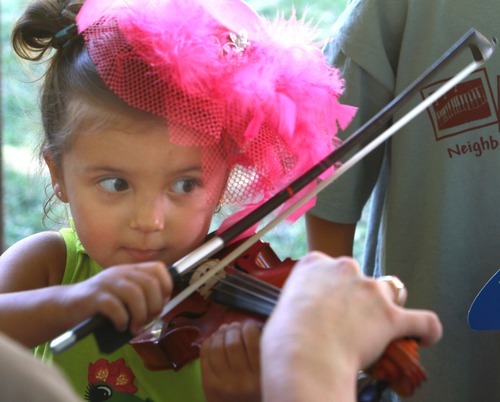 Rick Egan   |  The Salt Lake Tribune
Gabriella Davis tries out the violin at the 