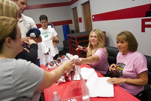 Chris Detrick | The Salt Lake Tribune 
Denise Hill and her daughter Sarah Nitta sign shirts for fans at Four Pillar Fitness in Bountiful on Saturday, June 11, 2011.  Hill won 
