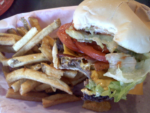 Lesli J. Neilson  |  The Salt Lake Tribune

The single buster burger (from Buster Burger) is a 1/4-pound patty, that's formed in-house using fresh ground beef, with American cheese, lettuce and tomato sandwiched between a lightly toasted Dunford Bakery bun. Once your order comes up, help yourself to the condiments bar, replete with ketchup, fry sauce, mayonnaise, mustard, honey mustard, ranch and barbecue sauce as well as flavored salts and peppers.