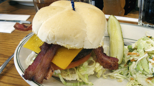 Lesli J. Neilson  | The Salt Lake Tribune

This is just one of the 50 combination burgers to be had at No Worries Cafe & Grill in Summit Park. This burger ($9.15) has 1/3 pound of beef with cheddar cheese, bacon, lettuce, tomato, red onion, pickles and mayonnaise sandwiched between a toasted kaiser bun. A pickle and the choice of French fries, onion rings, coleslaw, soup or green salad comes alongside.