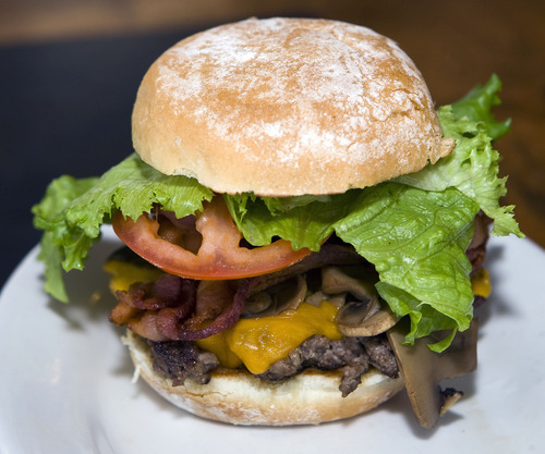 Al Hartmann  |  The Salt Lake Tribune
This is a 1/4-pound  burger with cheese from Salt City Burger Co. in Sandy.  Also added for a personal touch are sauteed mushrooms, tomato and lettuce.  The extensive fresh condiment bar allows customers to personalize the burger.