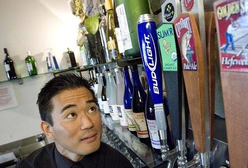 Djamila Grossman  |  The Salt Lake Tribune

Dojo restaurant co-owner Kelly Shiotani cannot get a club liquor license for his establishment. Instead he only has a restaurant license, which means he cannot mix drinks in public view. He poses for a portrait in front of the bar he now cannot use, at his restaurant in Salt Lake City on Thursday, June 23, 2011.