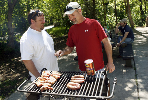Francisco Kjolseth  |  The Salt Lake Tribune
Pete Mount, left, and Jimmy Lipsey, of Monterey, La., grill in the picnic areas up Mill Creek on Tuesday, as one in the group exclaimed, 