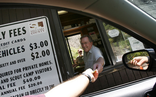 Francisco Kjolseth  |  The Salt Lake Tribune
Dave Parkinson collects the $3 vehicle charge while leaving Mill Creek on Tuesday. Twenty years ago, Mill Creek started charging a fee to use the canyon in order to make repairs and maintain the picnic areas.