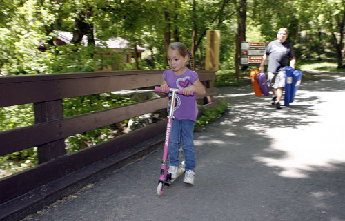 Francisco Kjolseth  |  The Salt Lake Tribune
Deja Maestas, 5, of Salt Lake City rides her scooter around one of the picnic areas up Mill Creek on Tuesday. Over the years, trails have been updated, making it fun for the kids. About 20 years ago, Mill Creek started charging a fee to use the canyon in order to make repairs and maintain the picnic areas.