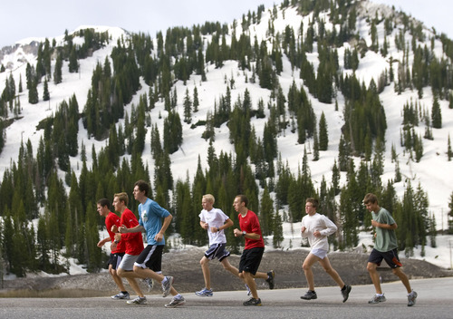 Al Hartmann  |  The Salt Lake Tribune
Members of the Alta High School cross country team take a high-altitude training run near Alta at the top of Little Cottonwood Canyon on Wednesday. The high country snowpack has lasted farther into the summer than usual.