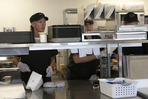 Margaret Distler  |  The Salt Lake Tribune
Ab's co-owner, Elizabeth Beutler, and Jen Smith, prepare orders during the 60th anniversary of Ab's Diner at the 4591 S. 5600 West location on Saturday. Beutler estimated that the diner's two locations would sell more than 5,000 burgers, which are normally priced at $1.59, for the 60th anniversary 60-cent hamburger special.