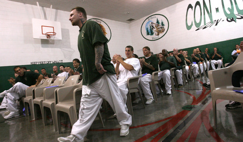 Leah Hogsten  |  The Salt Lake Tribune
Bruce Andrews is applauded by his fellow graduates as he walks to receive his diploma. Graduates of the Utah State Prison's Con-Quest substance-abuse program received a diploma  Thursday in Draper. The Con-Quest program is a residential substance-abuse treatment program that lasts 12 to 18 months.