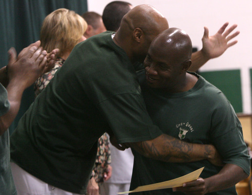 Leah Hogsten  |  The Salt Lake Tribune
Con-Quest graduate Stacy Sanders, right, is hugged by unit coordinator Alonzo Mosley Thursday at the Utah State Prison in Draper. Graduates of the Con-Quest substance-abuse program received a diploma Thursday. The Con-Quest program is a residential substance abuse treatment program that lasts 12 to 18 months.