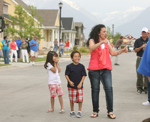 Leah Hogsten  |  The Salt Lake Tribune
  Jessica Gomez and her two children, Ellie, 5, and Jonah, 7, are welcomed at their new home in Daybreak by 
