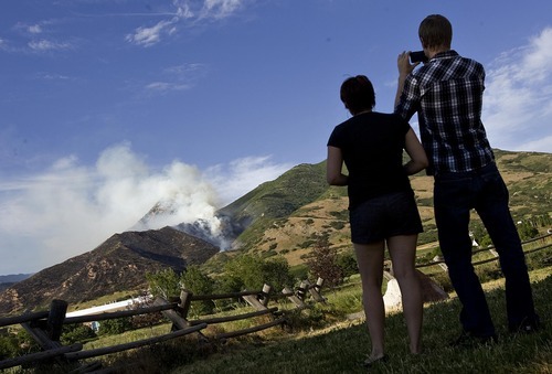 Djamila Grossman  |  The Salt Lake Tribune

Dani Wickingson and her boyfriend Elling Rusten take pictures as a wildfire burns in the hills above the University of Utah Research Park in Salt Lake City, Utah, on Sunday, July 3, 2011.