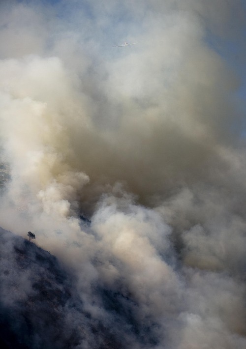 Djamila Grossman  |  The Salt Lake Tribune

A wildfire burns in the hills above the University of Utah Research Park in Salt Lake City, Utah, on Sunday, July 3, 2011.