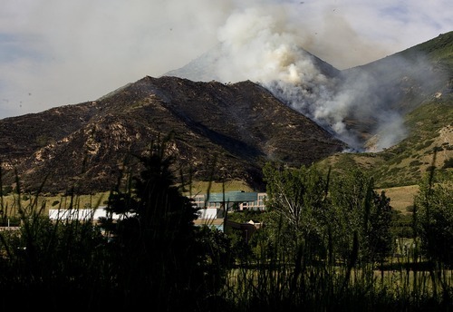 Djamila Grossman  |  The Salt Lake Tribune

A wildfire burns in the hills above the University of Utah Research Park in Salt Lake City, Utah, on Sunday, July 3, 2011.