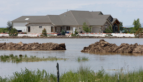 Francisco Kjolseth  |  The Salt Lake Tribune
One of the most threatened homes in West Warren due to a breach in the Weber River lies dangerously close to the flow that has been created to relieve some of the pressure.