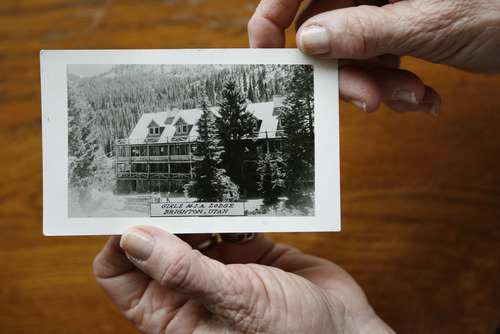 Francisco Kjolseth  |  The Salt Lake Tribune
Floss Waltman, director of the Brighton Girls Camp, which will celebrate its 90th anniversary in July, shows a picture of the original lodge that was burned down by skiers in 1963 and never rebuilt.