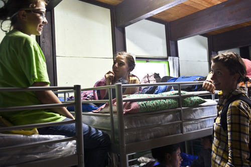 Chris Detrick | The Salt Lake Tribune 
Claire Matheson, Avery Dall and counselor Lena Carroll talk inside one of the cabins at Brighton Girls Camp on Wednesday, June 29, 2011. This is the camp's 90th summer, with 179 campers here this week.
