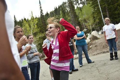 Chris Detrick | The Salt Lake Tribune 
Camper Megan Skog dances while playing 