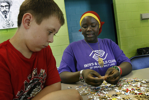 Scott Sommerdorf  |  The Salt Lake Tribune
Hawa Abdi works with Michael Shaver, as they build a puzzle together at the Boys & Girls Club, Thursday, June 30, 2011. Abdi is one of 29 members of the Capitol West Boys & Girls Club who graduated from high school this year.