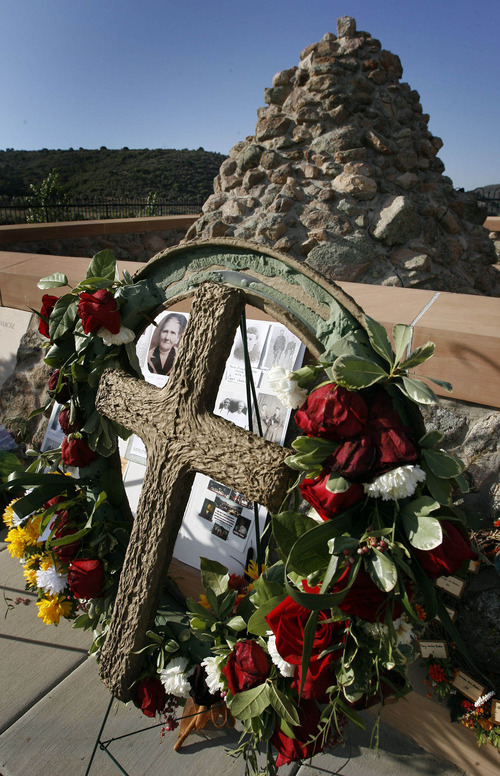 Tribune file photo
Flowers and photos were placed at the Mountain Meadows Memorial site by descendants and loved ones of the victims of the massacre, during the Mountain Meadows Massacre Memorial near Enterprise. The site has been named a national landmark.