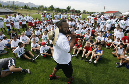 Francisco Kjolseth  |  The Salt Lake Tribune
Former Ute and current member of NY Jets Sione Po'uha encourages kids to give it their all as part of a youth football camp at East High on Thursday, June 30, 2011.