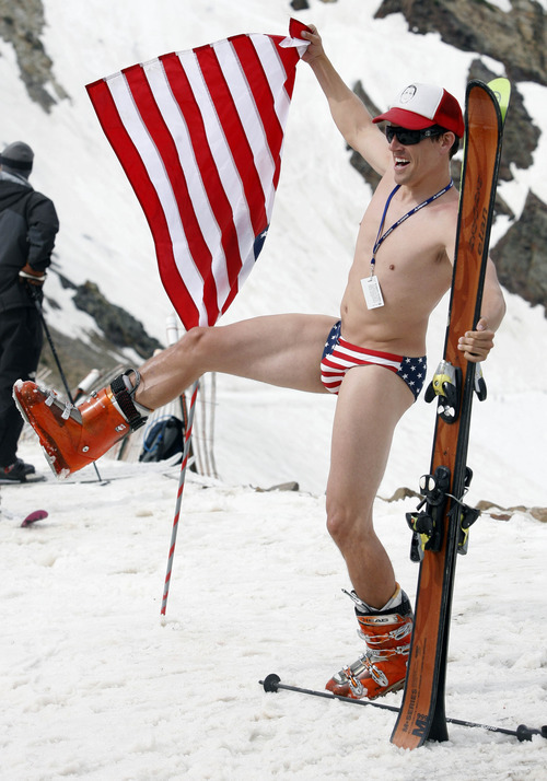 Rick Egan   |  The Salt Lake Tribune

Scott Brady, Salt Lake City, poses with the American Flag at the top of the tram,  before taking to the slopes at Snowbird, Monday, July, 4, 2011