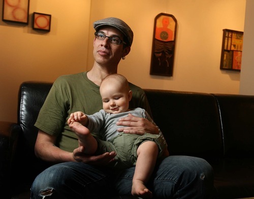 Leah Hogsten  |  The Salt Lake Tribune
Jorge Rojas, holding his son Felix, 11mos,,  in front of his work. Contemporary artist Jorge Rojas is having a show called 