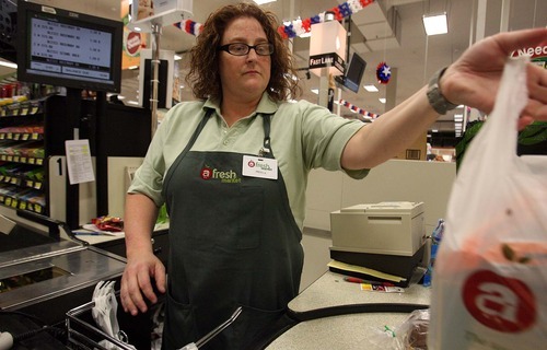 Leah Hogsten  |  The Salt Lake Tribune
Fresh Market employee Angela Neeley at work Thursday, June 23 2011, in Sandy. Five Fresh Market stores have closed during challenging times for the chain's parent company, Associated Food Stores.