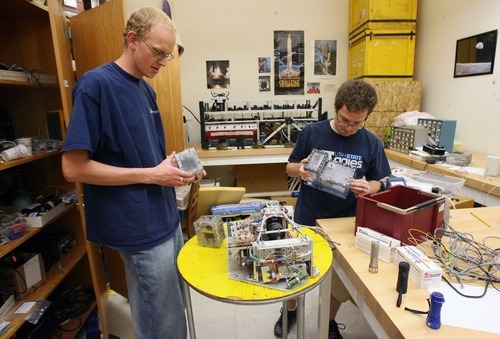 Steve Griffin  |  The Salt Lake Tribune

Utah State University students Ryan Martineau, left, and Troy Munro look through experiments that have flown on the space shuttle in a basement lab on the USU Logan campus Wednesday, June 29, 2011. They are working on a project that focuses on using boiling to remove heat and cool things in a microgravity environment.