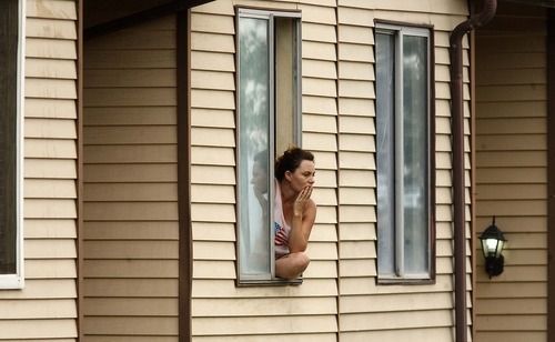 Trent Nelson  |  The Salt Lake Tribune
An unidentified neighbor looks on as police investigate the scene of an officer-involved shooting on Patricia Drive in Magna, Utah, Thursday, July 7, 2011
