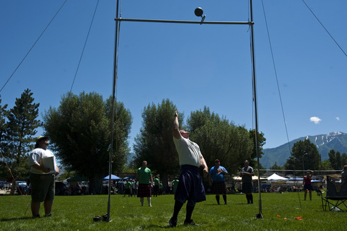 Photo by Chris Detrick | The Salt Lake Tribune 
Josh Wiggins, of South Jordan, throws a 56lb weight over a 14' 1