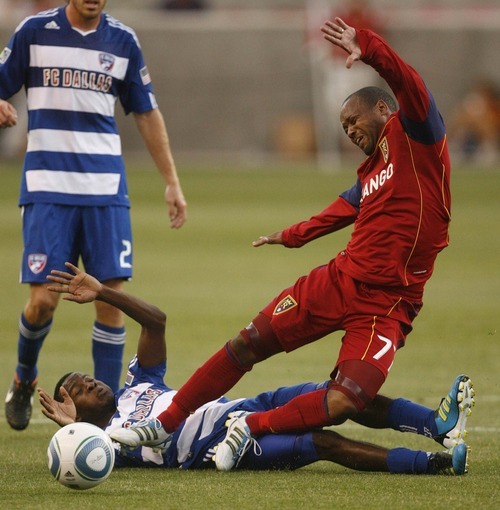 Trent Nelson  |  The Salt Lake Tribune
RSL's Andy Williams is tripped up by FC Dallas's Marvin Chavez. Real Salt Lake vs. FC Dallas at Rio Tinto Stadium in Sandy, Utah, Saturday, July 9, 2011