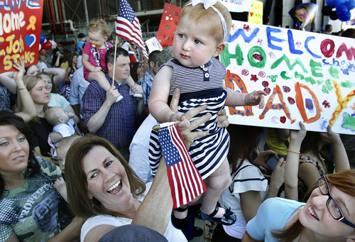 Scott Sommerdorf  |  The Salt Lake Tribune
Lt. Ryan Becker's mother Joy, holds up his 10-month-old daughter Mya as the family waits for him to return with the rest of the Utah National Guard's 118th Engineer (Sapper) Company Sunday, July 10, 2011. The unit returned from its 12-month deployment in Afghanistan.