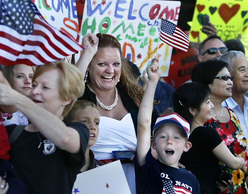 Scott Sommerdorf  |  The Salt Lake Tribune
Kristie Fitzsimmons cheers as the plane carrying her husband, Sgt. Matt Fitzsimmons as the rest of the Utah National Guard's 118th Engineer (Sapper) Company returned Sunday, July 10, 2011. The couple was married just three months ago during Sgt. Fitzsimmon's leave.