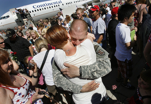 Scott Sommerdorf  |  The Salt Lake Tribune
Lt. Jeremy Wells, hugs his wife Brianna as he returned to Utah with the Utah National Guard's 118th Engineer (Sapper) Company, Sunday, July 10, 2011. The unit completed its 12-month deployment to Afghanistan.