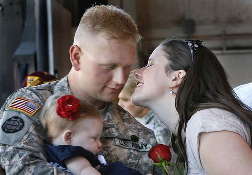 Scott Sommerdorf  |  The Salt Lake Tribune
Megan Hunter of Orem, reaches in to kiss her husband, Spc. Steven Hunter after he returned from Afghanistan with the Utah National Guard's 118th Engineer (Sapper) Company,  Sunday, July 10, 2011. Spc. Hunter is holding his 6-month-old daughter Hallie whom he is seeing for the first time.