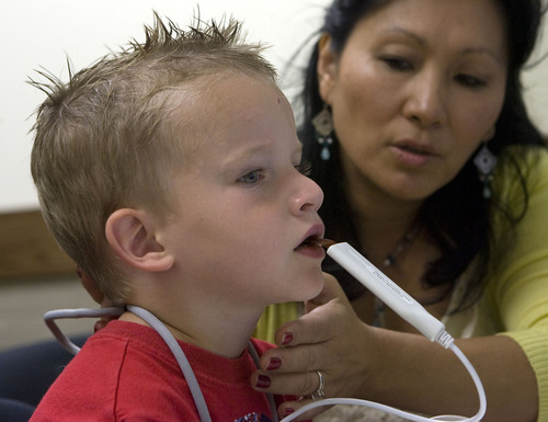 Al Hartmann  |  The Salt Lake Tribune
Five-year-old Breyton Banks uses a device called a palatometer in a speech therapy session with speech language pathologist Ann Dorais at the Comprehensive Clinic on BYU campus.   The custom-fit retainer allows therapists to use computers to watch precisely how kids pronounce words and help them correct their speech in real time.
