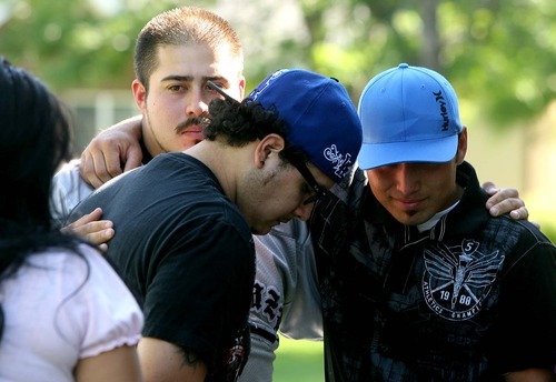 Leah Hogsten  |  The Salt Lake Tribune
From left, Victor Estrada, Chris Barrera and Nelson Lopez weep for the loss of their friend Norberto Mendez Hernandez, of Logan, who was killed Sunday in Afghanistan. Friends, family and loved ones of Mendez Hernandez, 22, held a vigil Tuesday in Logan at the home of his parents.