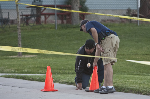 Chris Detrick  |  The Salt Lake Tribune 
Unified Police investigate the scene of a shooting Tuesday at Mountain Man Park in Kearns. One victim was shot in his leg near 4900 South Heath Avenue (5150 West).